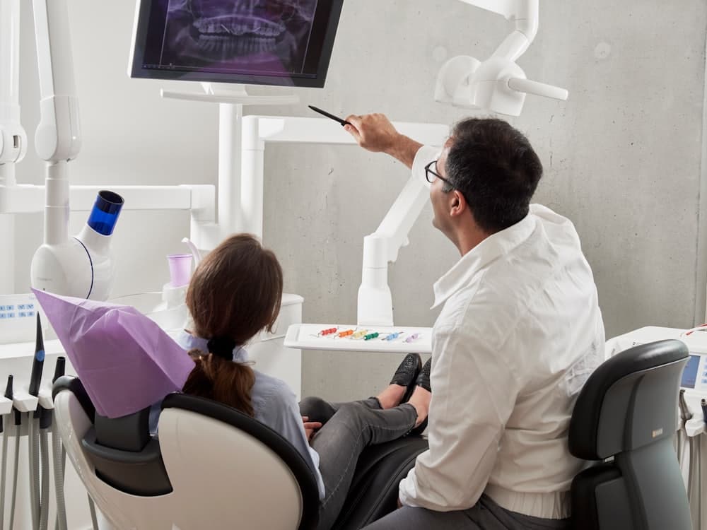 A dentist reviewing an X-ray with a patient